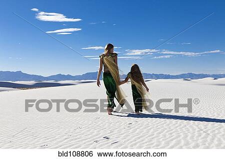 Caucasian mother and daughter walking in desert View Large Photo Image Stock Photograph - Caucasian mother and daughter walking in desert. Fotosearch