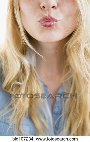 Picture - Caucasian woman blowing a kiss. Fotosearch