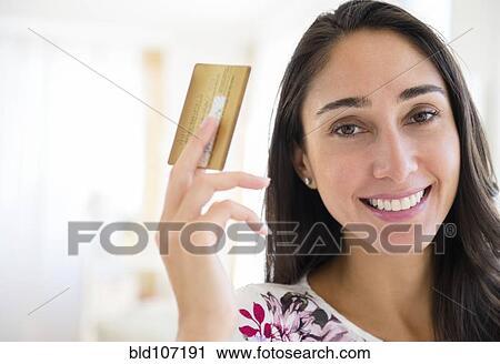 Stock Image - Caucasian woman holding credit card. Fotosearch