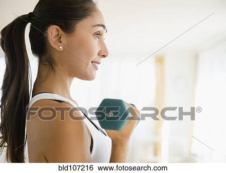 Stock Photograph - Caucasian woman lifting weights. Fotosearch