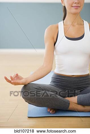 Caucasian woman meditating on exercise mat View Large Photo Image Stock Photo - Caucasian woman meditating on exercise mat. Fotosearch