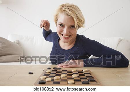 Caucasian woman playing checkers View Large Photo Image Stock Image - Caucasian woman playing checkers. Fotosearch