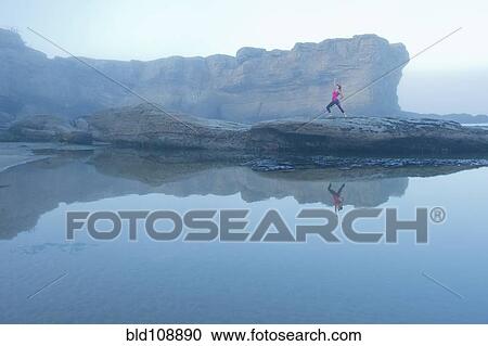 Caucasian woman practicing yoga on rock formations View Large Photo Image Stock Image - Caucasian woman practicing yoga on rock formations. Fotosearch