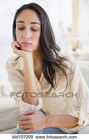 Stock Photo - Caucasian woman resting chin in hand. Fotosearch