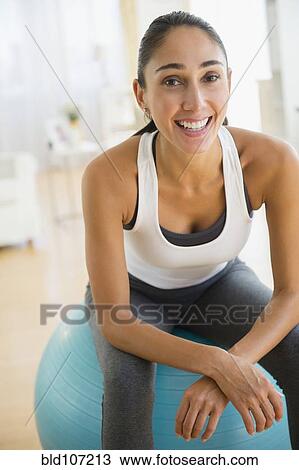 Caucasian woman sitting on exercise ball View Large Photo Image Stock Image - Caucasian woman sitting on exercise ball. Fotosearch