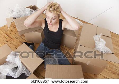Caucasian woman unpacking boxes in new home View Large Photo Image Stock Photo - Caucasian woman unpacking boxes in new home. Fotosearch