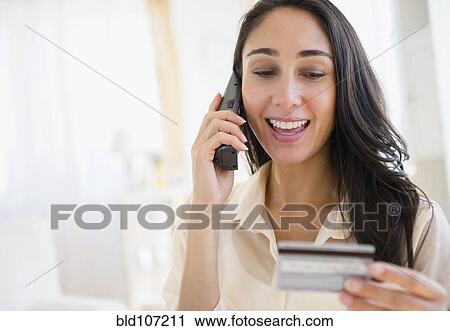 Caucasian woman using credit card on telephone View Large Photo Image Stock Image - Caucasian woman using credit card on telephone. Fotosearch