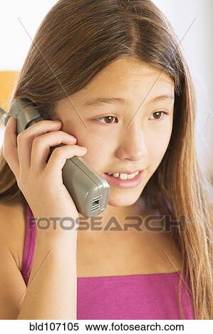 Close up of girl talking on phone View Large Photo Image Stock Photography - Close up of girl talking on phone. Fotosearch