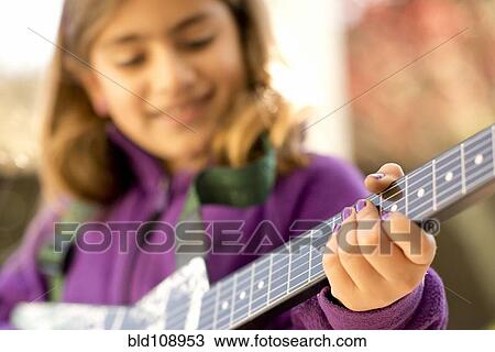 Close up of mixed race girl's fingernails playing guitar View Large Photo Image Stock Image - Close up of mixed race girl's fingernails playing guitar. Fotosearch