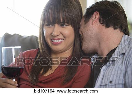 Picture - Couple relaxing on sofa. Fotosearch