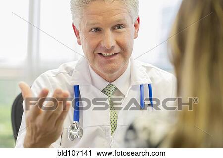Doctor and patient talking in office View Large Photo Image Stock Image - Doctor and patient talking in office. Fotosearch