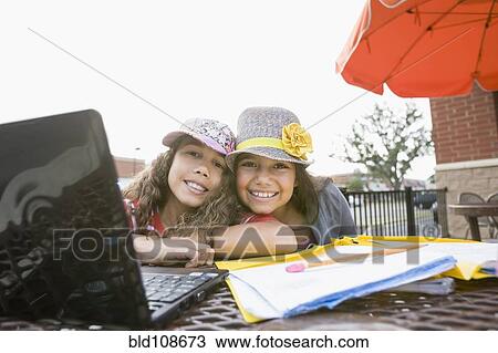 Girls doing homework at cafe View Large Photo Image Stock Image - Girls doing homework at cafe. Fotosearch