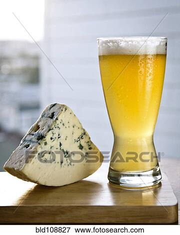 Glass of beer with wedge of cheese View Large Photo Image Stock Photo - Glass of beer with wedge of cheese. Fotosearch