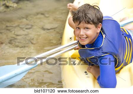 Hispanic boy sitting in canoe View Large Photo Image Stock Image - Hispanic boy sitting in canoe. Fotosearch