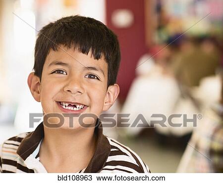 Stock Image - Hispanic boy smiling with gap in his teeth. Fotosearch