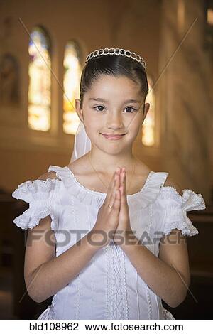 Hispanic girl with hands clasped in church View Large Photo Image Stock Image - Hispanic girl with hands clasped in church. Fotosearch