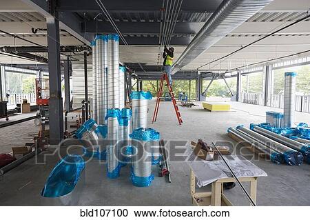 Hispanic man working at construction site View Large Photo Image Stock Image - Hispanic man working at construction site. Fotosearch