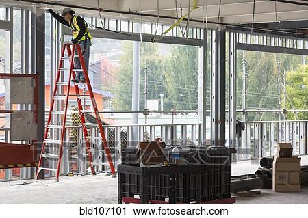 Stock Image - Hispanic man working at construction site. Fotosearch