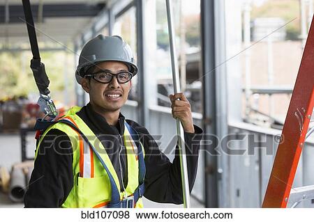 Hispanic man working at construction site View Large Photo Image Stock Photo - Hispanic man working at construction site. Fotosearch