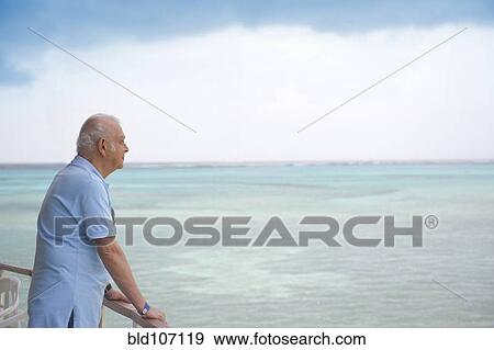 Hispanic older man overlooking ocean View Large Photo Image Stock Photo - Hispanic older man overlooking ocean. Fotosearch
