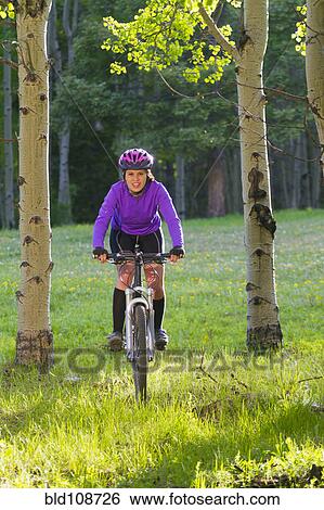 Hispanic teenager riding bicycle in woods View Large Photo Image Stock Photograph - Hispanic teenager riding bicycle in woods. Fotosearch