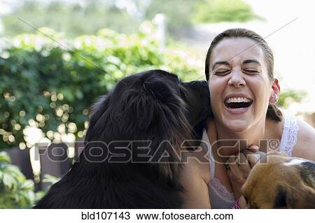 Hispanic woman playing with dogs View Large Photo Image Stock Image - Hispanic woman playing with dogs. Fotosearch