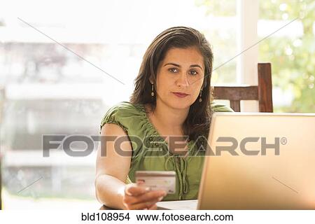 Hispanic woman shopping online View Large Photo Image Picture - Hispanic woman shopping online. Fotosearch