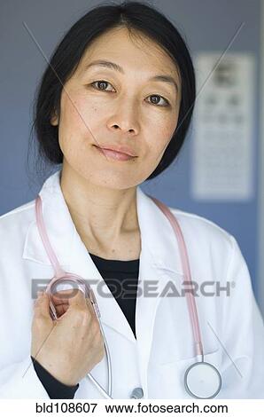 Japanese doctor standing in office View Large Photo Image Stock Photo - Japanese doctor standing in office. Fotosearch