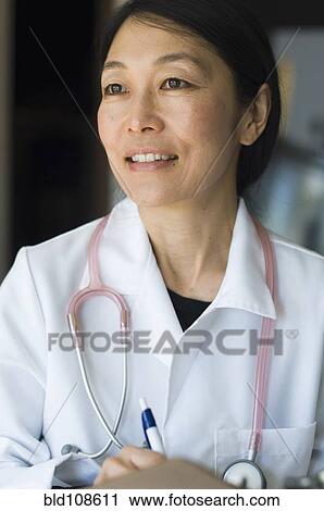 Japanese doctor writing on clipboard View Large Photo Image Stock Image - Japanese doctor writing on clipboard. Fotosearch