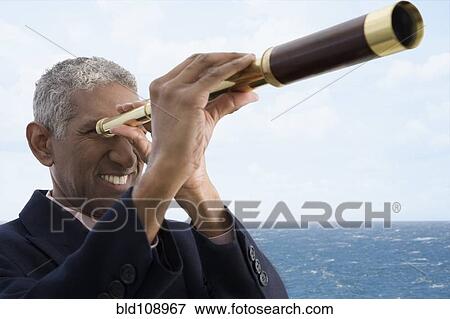 Stock Photo - Mixed race businessman using telescope. Fotosearch