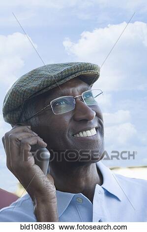 Mixed race man talking on cell phone View Large Photo Image Stock Image - Mixed race man talking on cell phone. Fotosearch