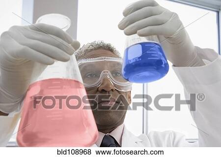 Stock Photo - Mixed race scientist working in lab. Fotosearch