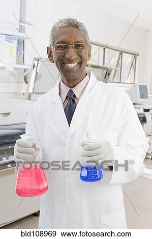 Stock Photo - Mixed race scientist working in lab. Fotosearch