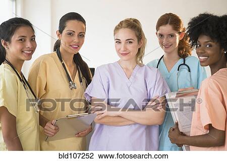 Nurses in colorful scrubs talking in hospital View Large Photo Image Stock Image - Nurses in colorful scrubs talking in hospital. Fotosearch