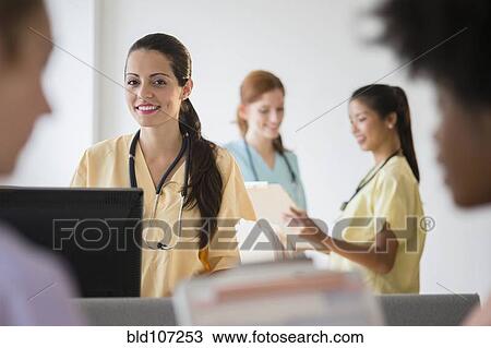 Nurses in colorful scrubs talking in hospital View Large Photo Image Stock Image - Nurses in colorful scrubs talking in hospital. Fotosearch