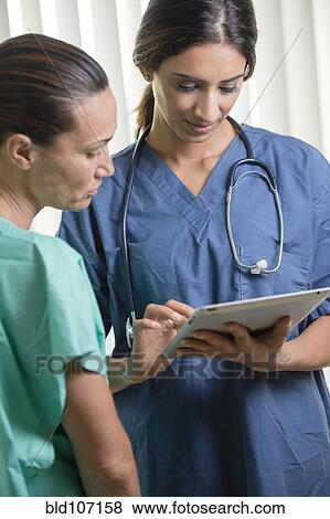 Nurses using tablet computer View Large Photo Image Stock Photo - Nurses using tablet computer. Fotosearch