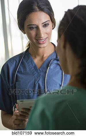 Nurses using tablet computer View Large Photo Image Stock Photo - Nurses using tablet computer. Fotosearch