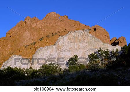Picture - Red cliffs rising in rural landscape. Fotosearch