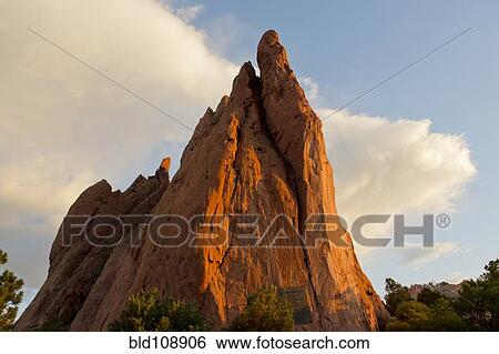 Stock Photograph - Red cliffs rising in rural landscape. Fotosearch