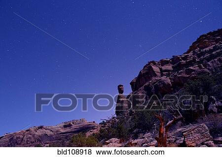 Stock Photo - Rock formations in desert at night. Fotosearch