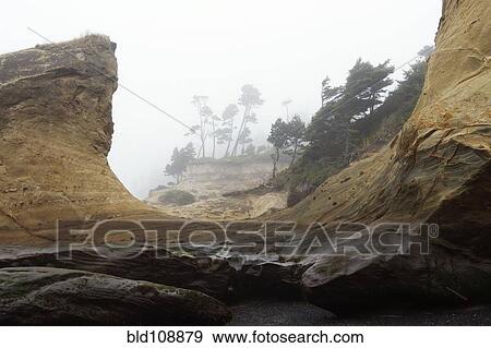 Rock formations on foggy coastline View Large Photo Image Stock Photo - Rock formations on foggy coastline. Fotosearch