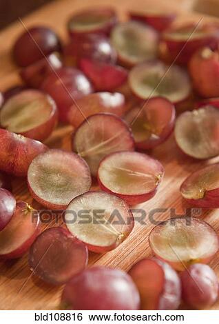 Sliced grapes on wooden board View Large Photo Image Stock Photograph - Sliced grapes on wooden board. Fotosearch