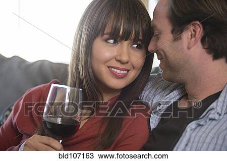 Smiling couple relaxing on sofa View Large Photo Image Stock Image - Smiling couple relaxing on sofa. Fotosearch