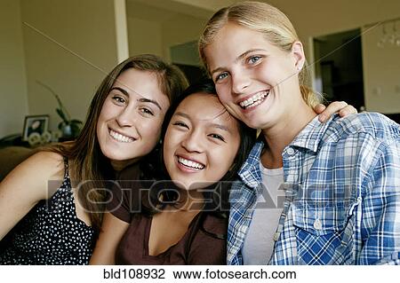Smiling girls sitting together View Large Photo Image Stock Image - Smiling girls sitting together. Fotosearch