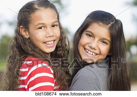 Picture - Smiling girls walking outdoors. Fotosearch