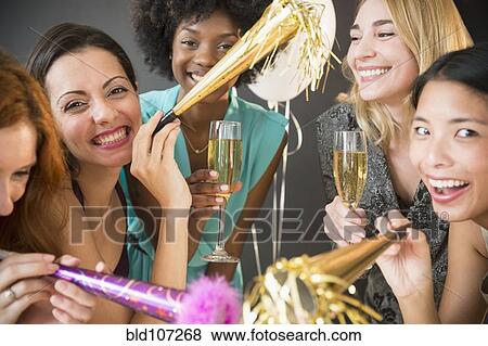 Stock Photo - Smiling women celebrating at party. Fotosearch