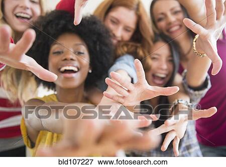 Smiling women reaching forward View Large Photo Image Stock Photo - Smiling women reaching forward. Fotosearch