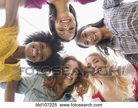 Stock Photography - Smiling women standing in circle. Fotosearch