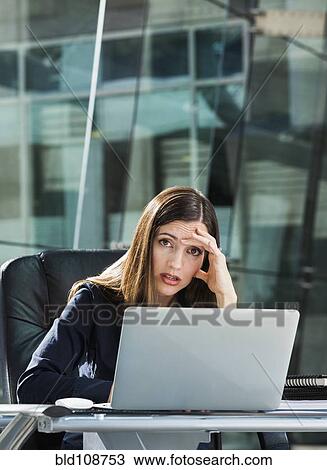 Stressed Caucasian businesswoman at laptop View Large Photo Image Stock Image - Stressed Caucasian businesswoman at laptop. Fotosearch