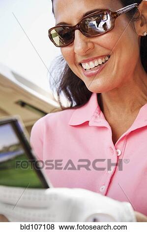 Woman keeping score during golf game View Large Photo Image Stock Photo - Woman keeping score during golf game. Fotosearch